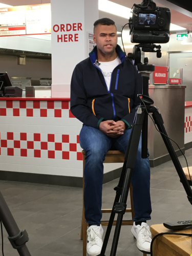 Young Voices member, Rainbow being interviewed in a Five Guys restaurant.