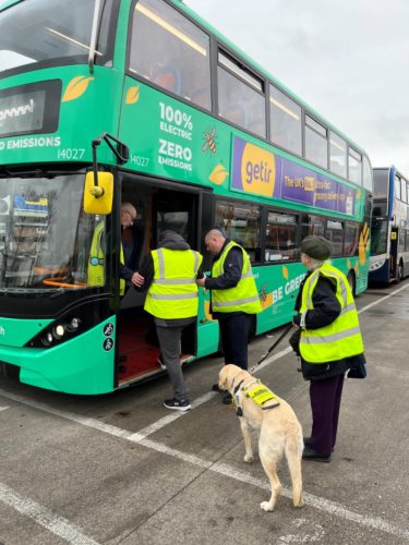 event attendees in high vis boarding bus.