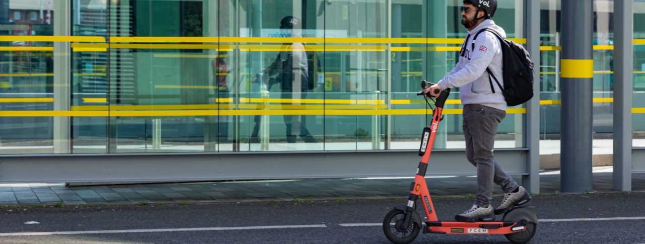 Voi e-scooter riding past Liverpool bus station