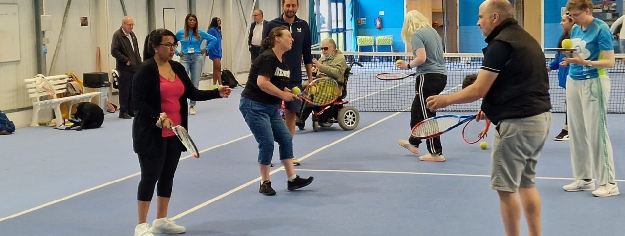 People trying VI tennis at tennis club