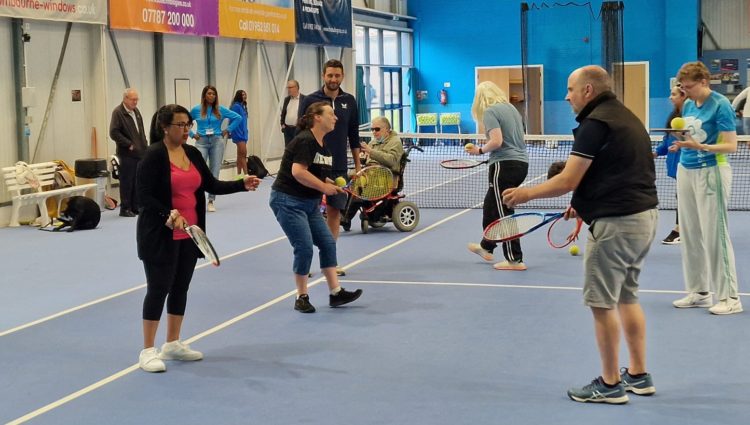 People trying VI tennis at tennis club