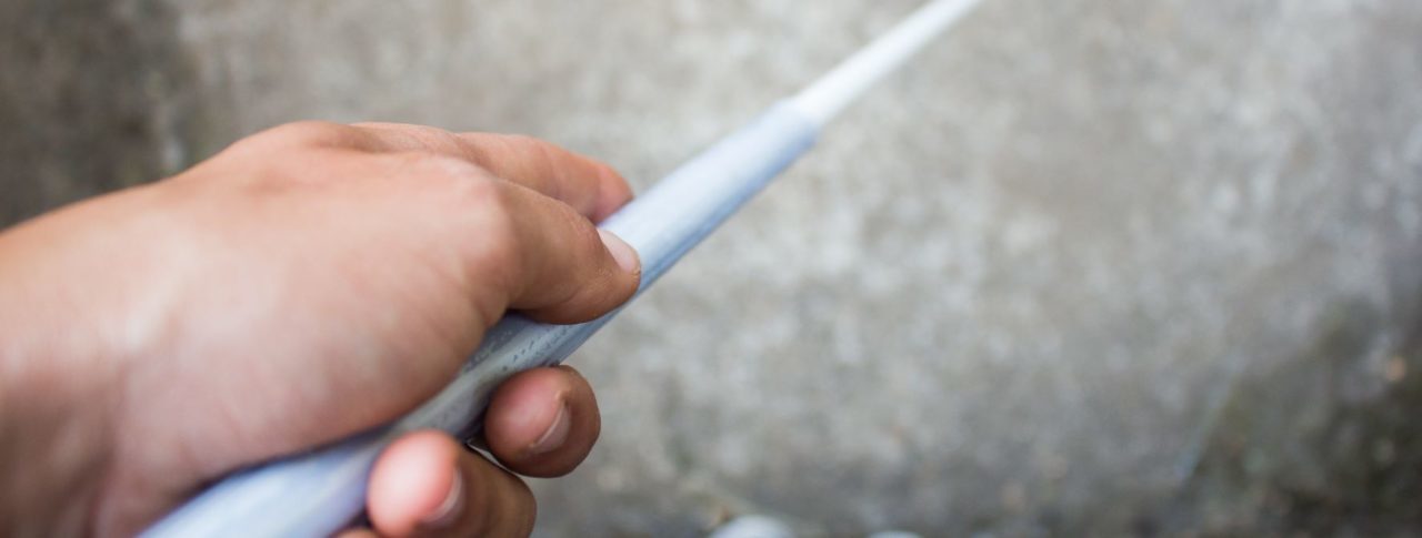 Blind person holding a white cane