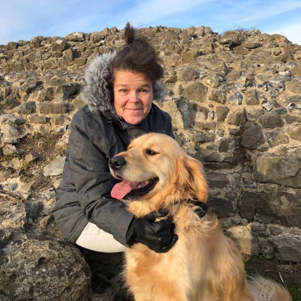 Sam Fox, a volunteer for Essex Sight Loss Council who is blind, pictured with a golden retriever