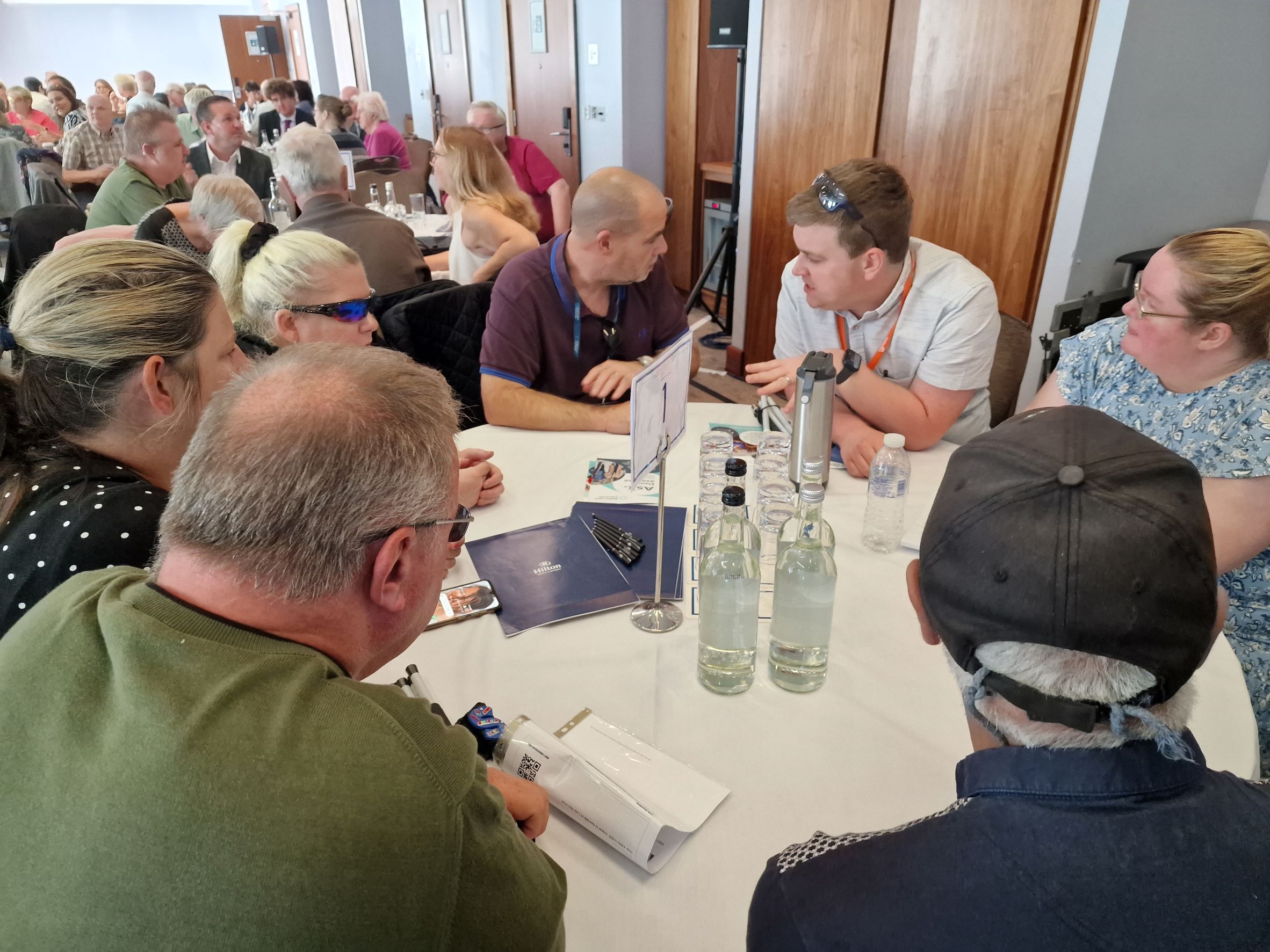 Blind and partially sighted attendees sat around tables discussing key topics focused on employment, transport, health and wellbeing, and accessibility.
