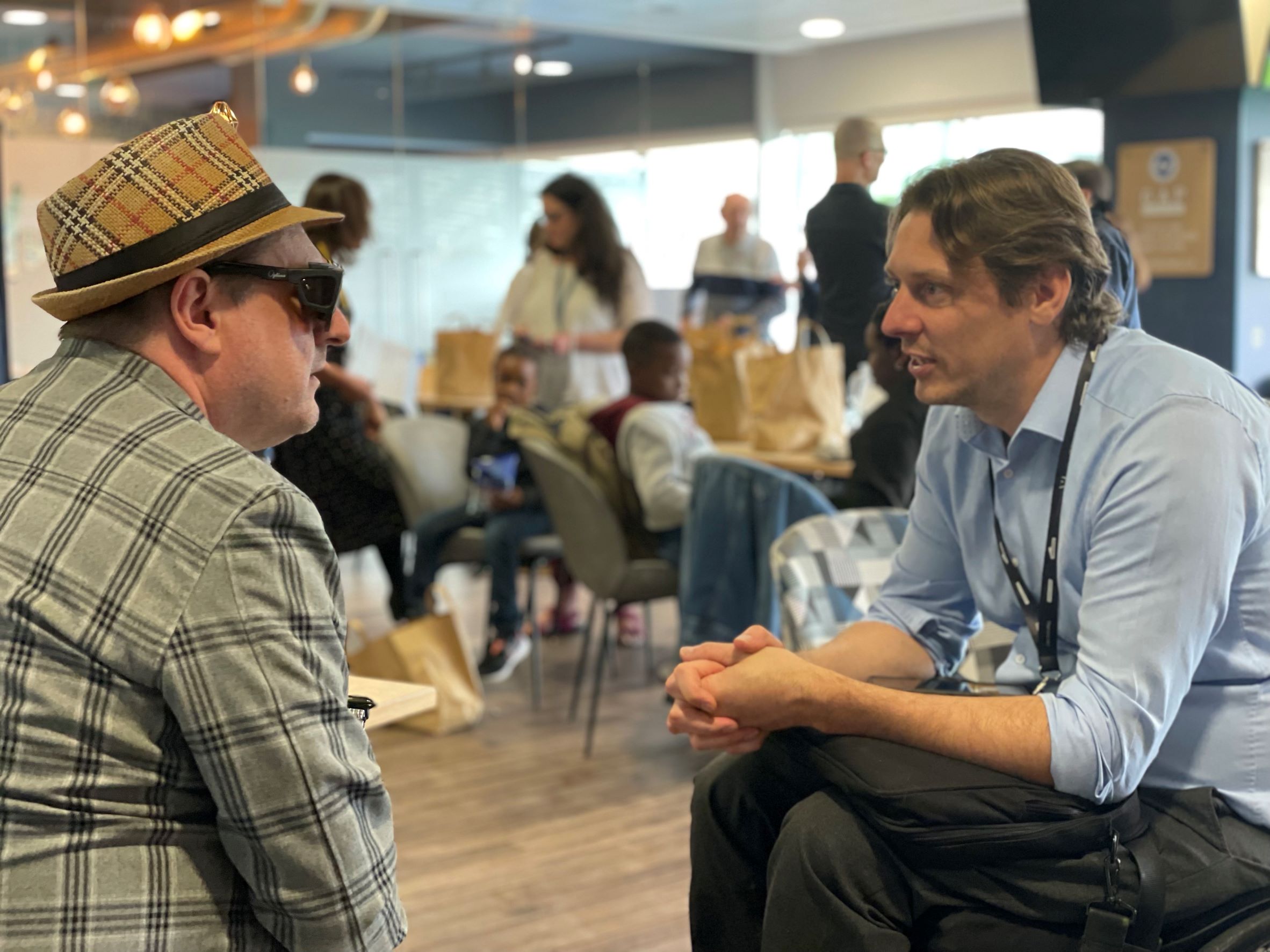 Sight Loss Council member Paul Goddard deep in conversation with Carl Martin (Govia Thameslink Railways) at the Make Transport Accessible event.