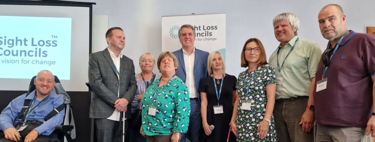 Merseyside Sight Loss Council members with Liverpool City Region Mayor Steve Rotheram and Engagement Manager Kelly Barton at the event. They are stood in front of a Sight Loss Council banner.