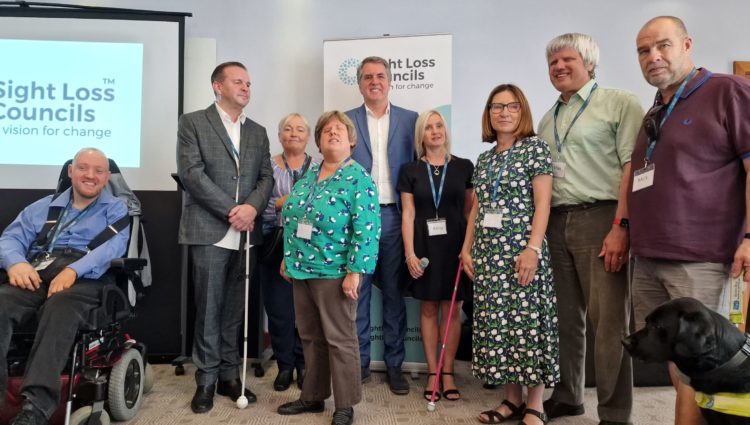 Merseyside Sight Loss Council members with Liverpool City Region Mayor Steve Rotheram and Engagement Manager Kelly Barton at the event. They are stood in front of a Sight Loss Council banner.