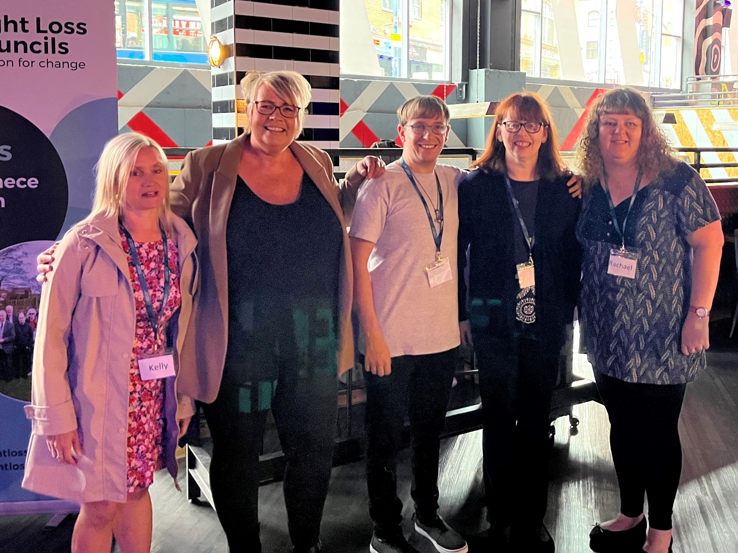 Engagement Manager Kelly Barton with members of the Sight Loss Council and Debs from the Marketing Team at the Arndale Centre. They are stood in a line smiling at the camera.