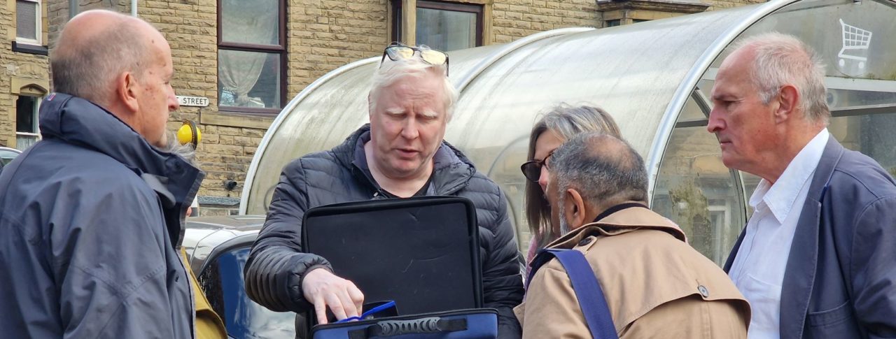 Senior Engagement Manager Iain Mitchell distributing simulation spectacles to everyone taking part in the walk.