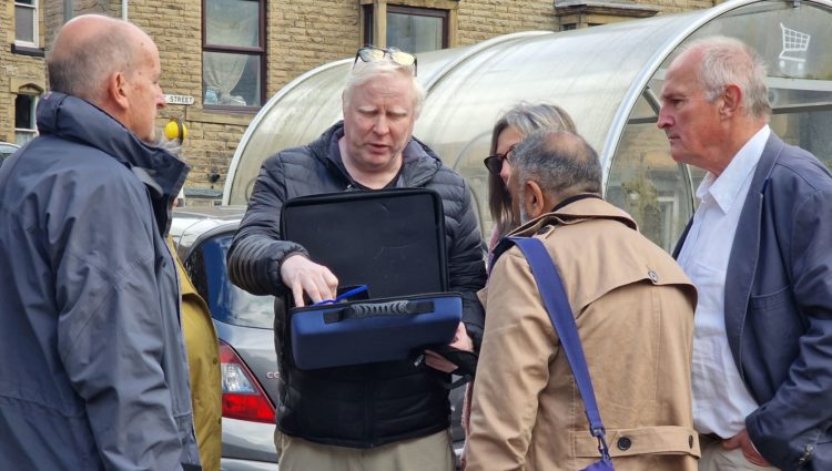 Senior Engagement Manager Iain Mitchell distributing simulation spectacles to everyone taking part in the walk.