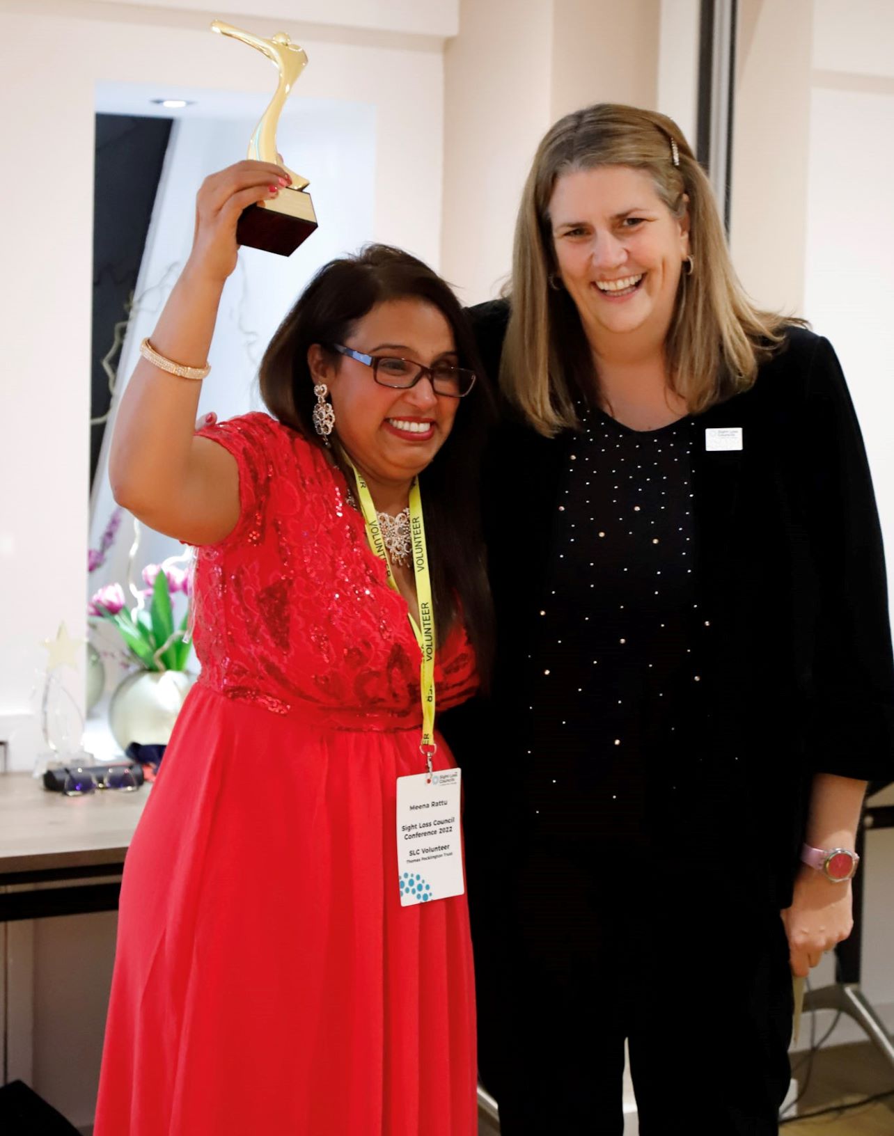 Meena Ratu, Black Country SLC, with Emma Hughes, Director of Services. Meena is holding her award above her head.