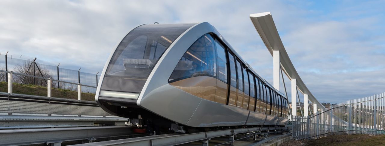 Image shows the Luton Rising DART shuttle train, going through a platform.