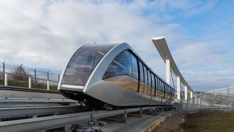 Image shows the Luton Rising DART shuttle train, going through a platform.