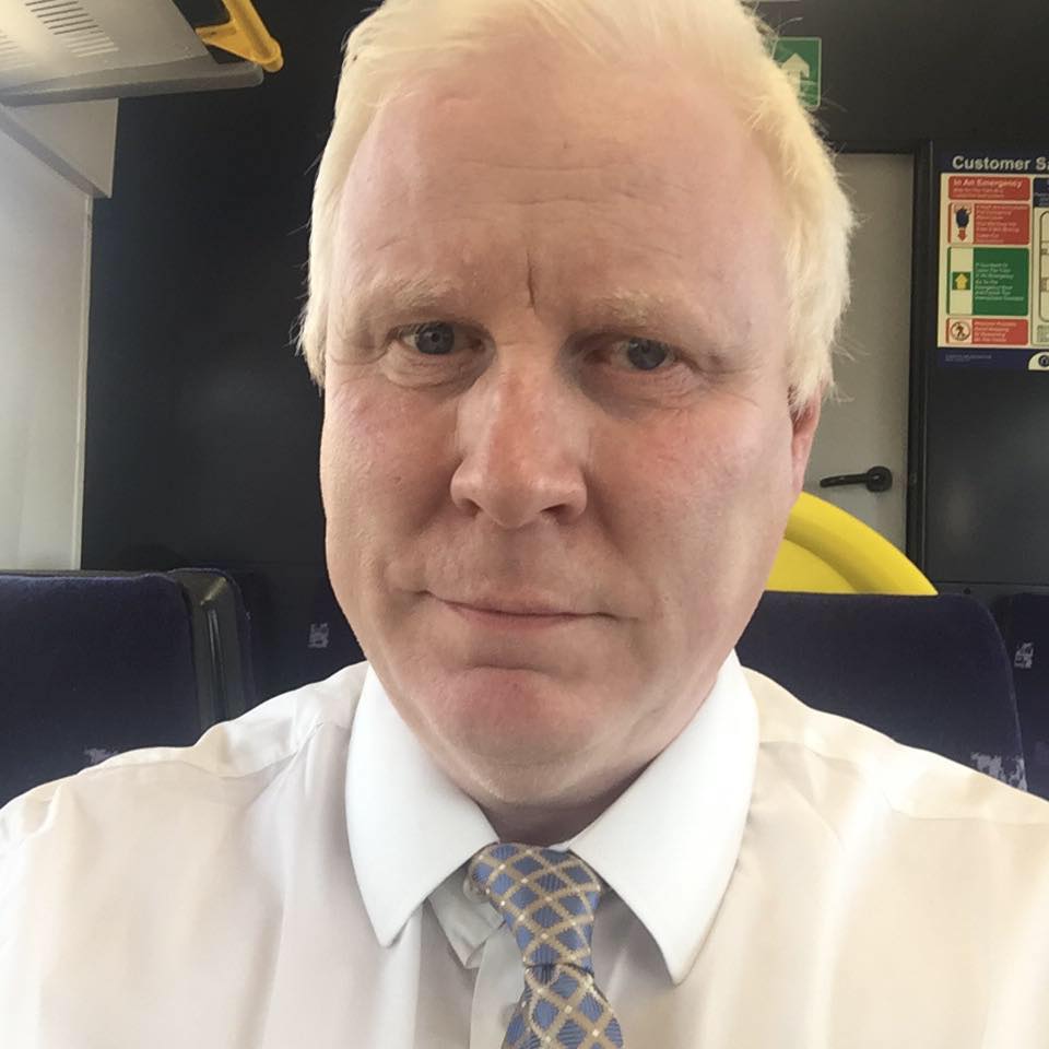 Headshot of Iain Mitchell, Senior Engagement Manager for York & Humber. He is looking at the camera smiling. he is wearing a white shirt and grey, patterned tie.