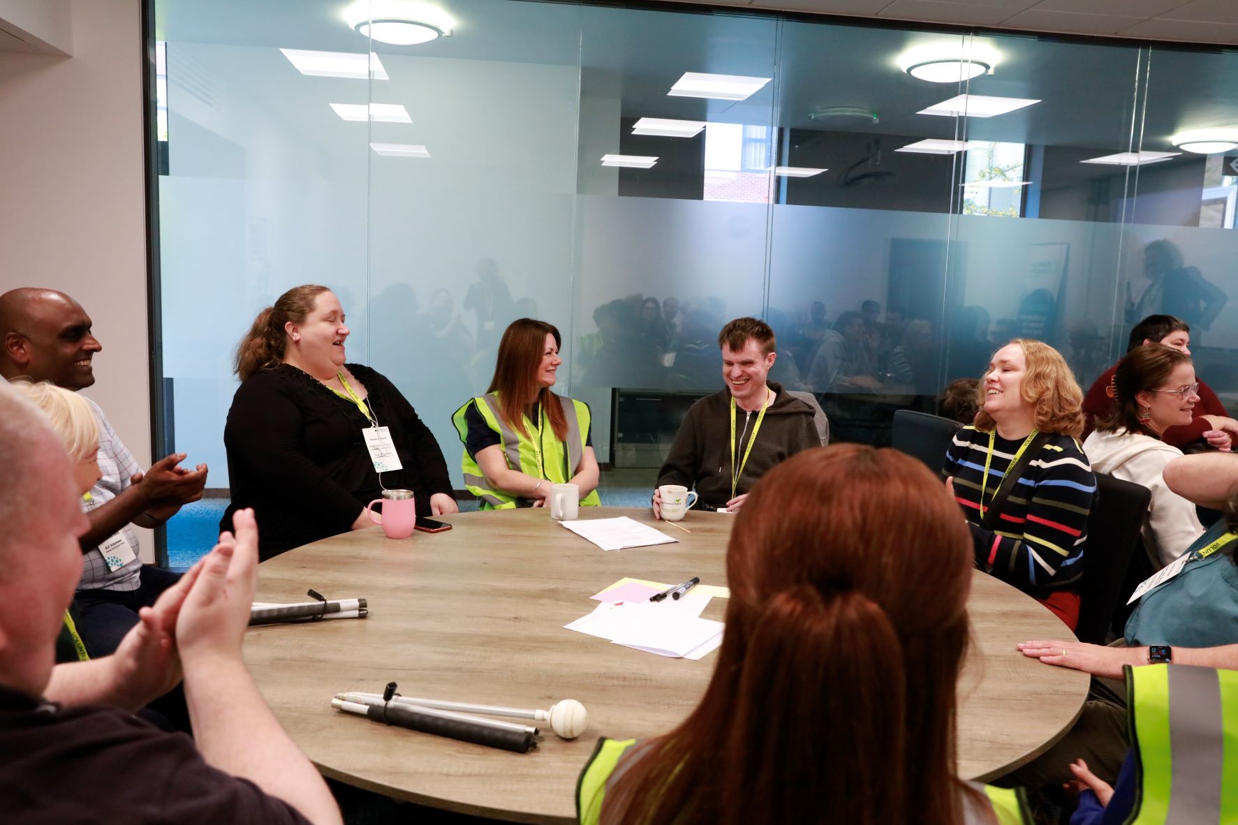 Delegates sitting around a table during the AIS workshop at the SIght Loss Council conference. They are talking and laughing with each other.