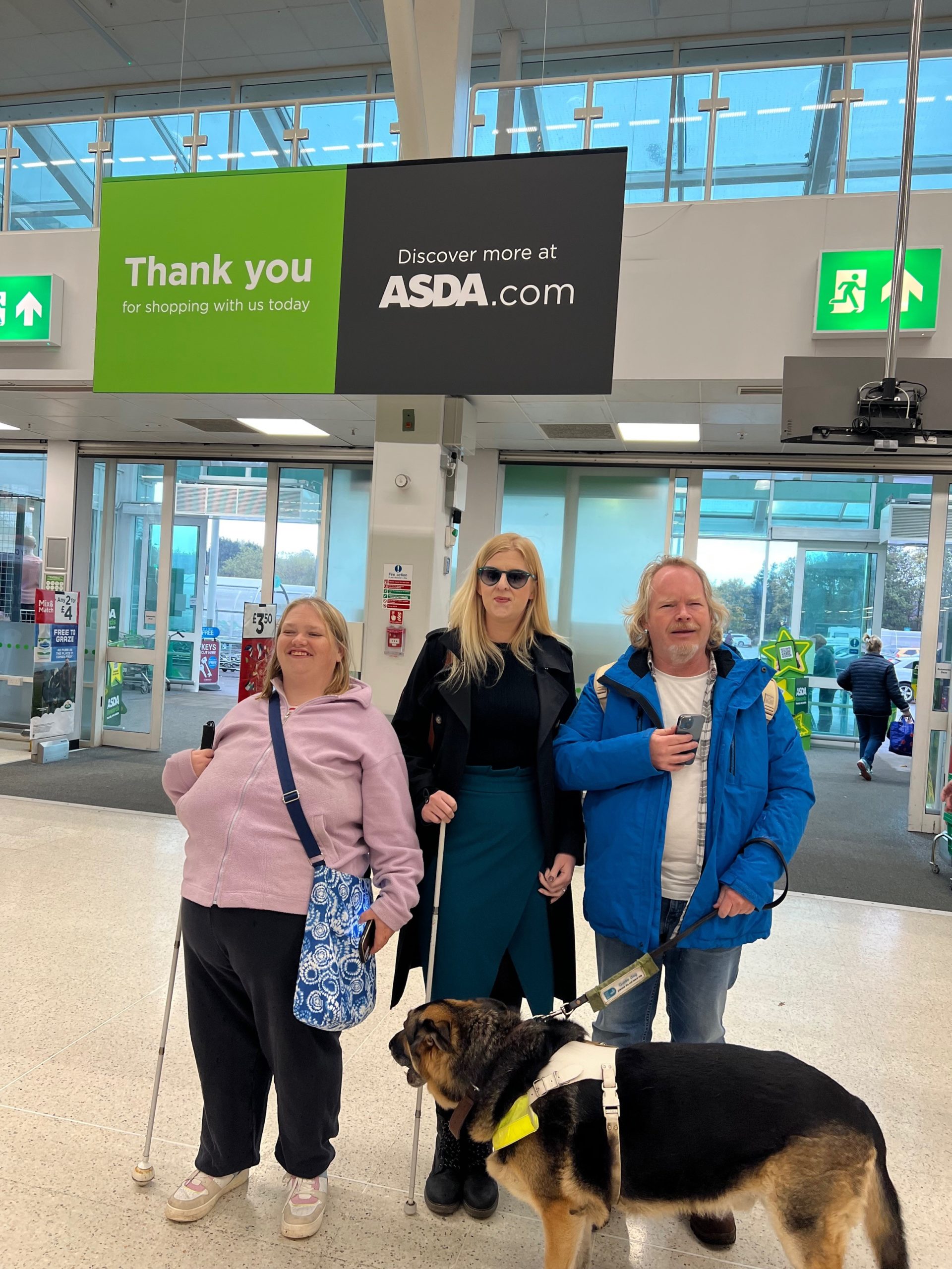 From left to right: Lianne McKeon, Birmingham SLC member, Louise Connop, Senior Engagement Manager for central England, and Steve Keith, Birmingham SLC member. They are standing next to each other at the entrance of ASDA.