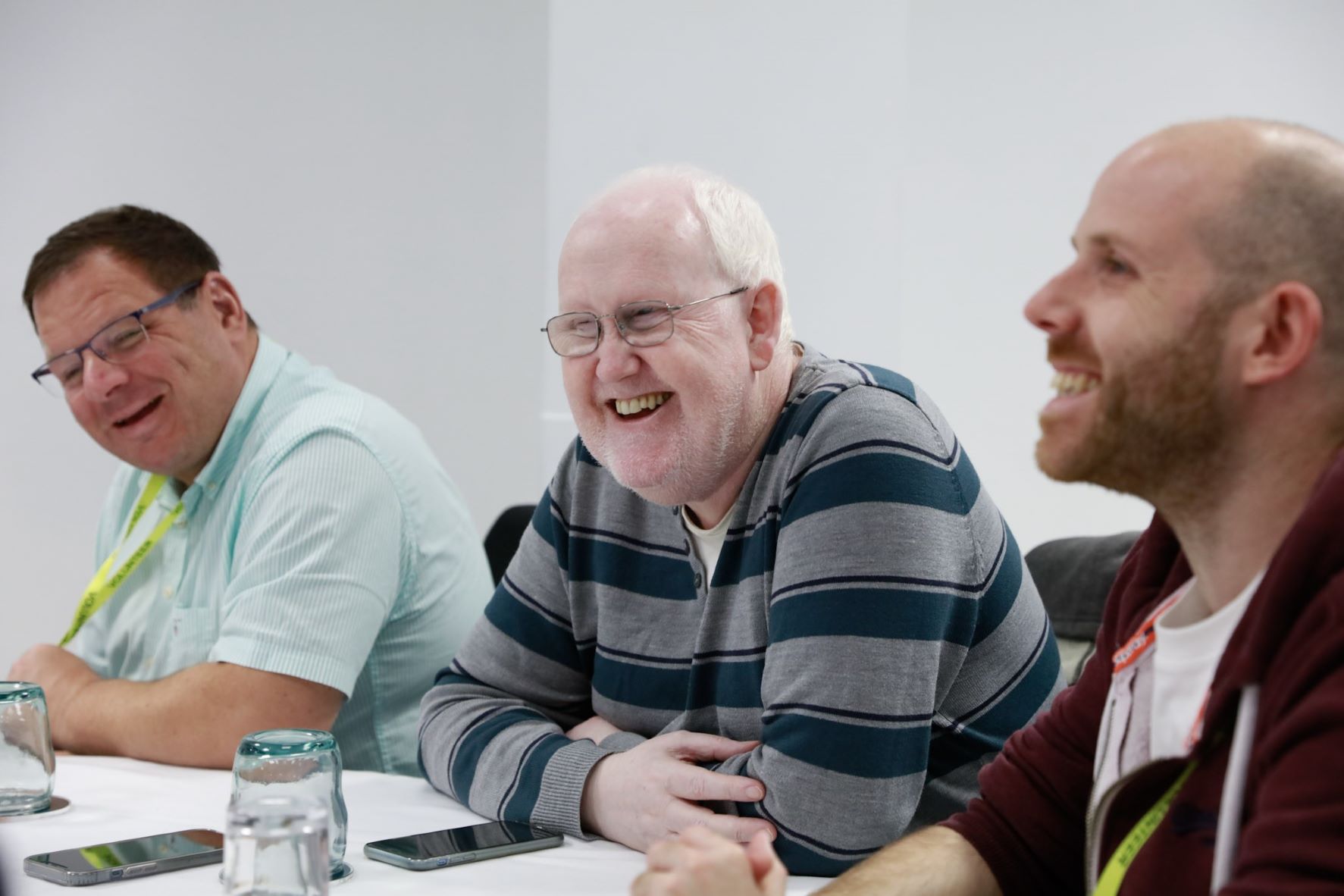 Martin Kearney, Tyne and Wear SLC member, is sat at a table with two other delegates. They are all relaxed and smiling.