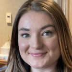 Headshot of Belle Whitely, West Yorkshire SLC member. Belle has long, brown, hair. She is looking at the camera, smiling.