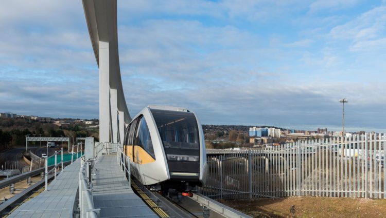 Image shows the Luton DART train driving alongside a platform.