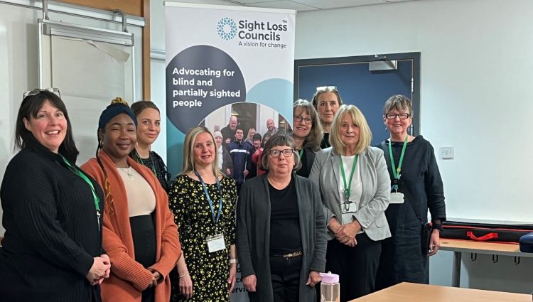 Group shot of Kelly, EM for Greater Manchester SLC, and Ada, SLC member. They are stood with staff members from John Lewis who participated in the VI awareness session.