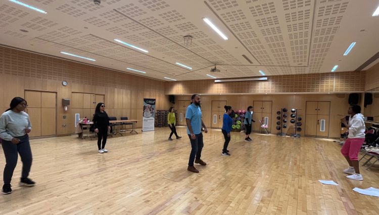 Attendees at the Access Gym's event, participating in the VI Zumba session in a dance studio at Better Gym.