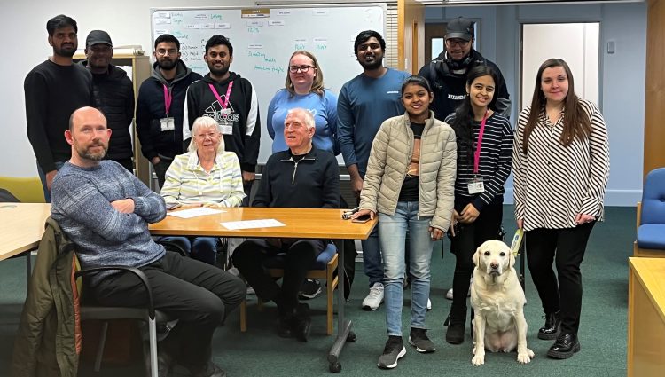 Bedfordshire SLC Engagement Manager, Samantha, and guide dog Lizzie, pictured with SLC members Stefan, and Phil, and Ethos Farm Staff. They are stood in a group, smiling at the camera.