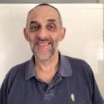 Headshot of Worcestershire SLC member, Keith Cairns. He is wearing a navy polo shirt, and smiling at the camera.
