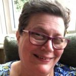 Photo of Val Humphries, Worcestershire SLC member. She is seated, smiling at the camera.