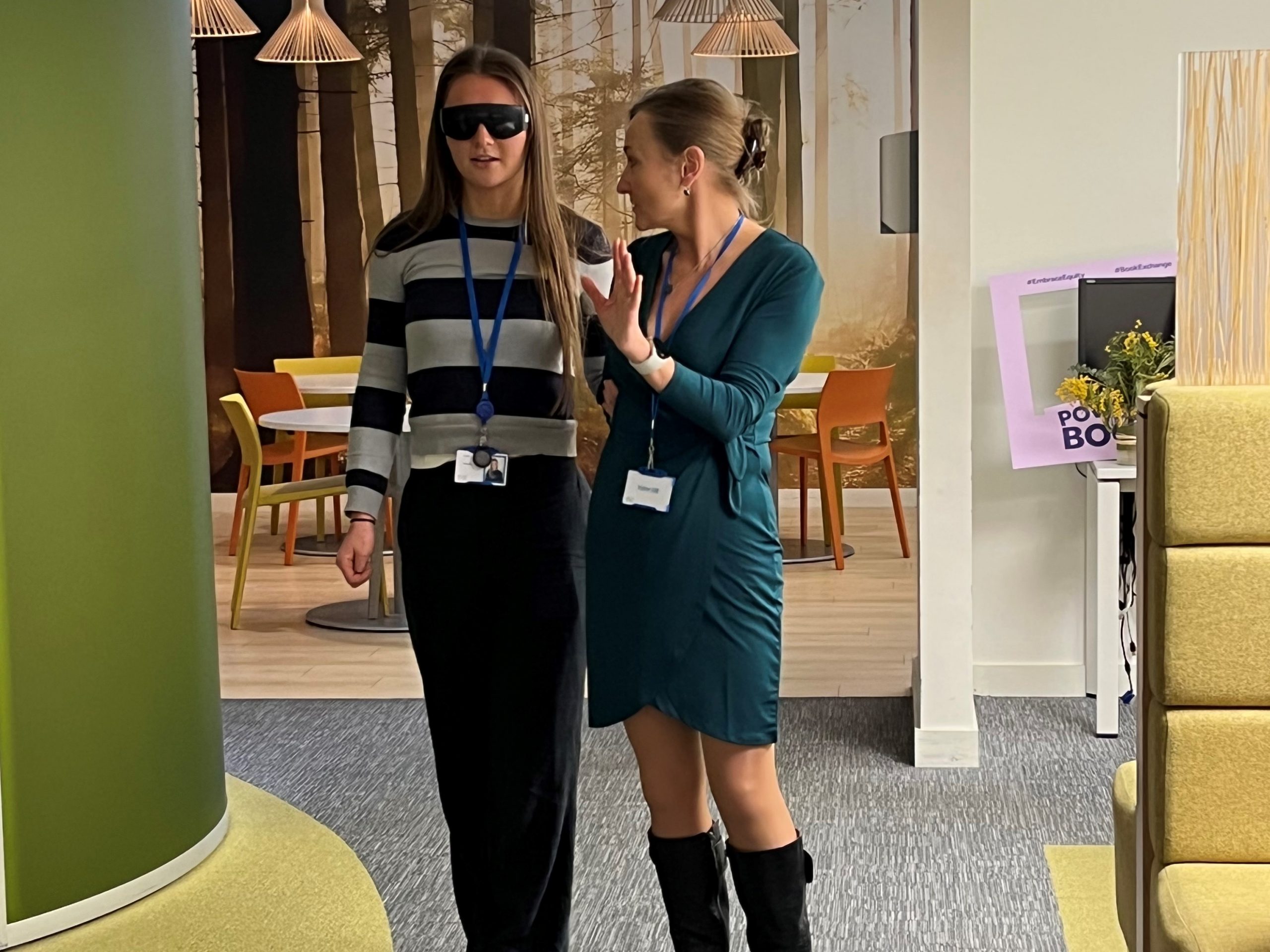 Jen Sweeny, Corporate Engagement Manager for Thomas Pocklington Trust, talking to a member of the Barclays team who is wearing sim specs during sighted guide training.