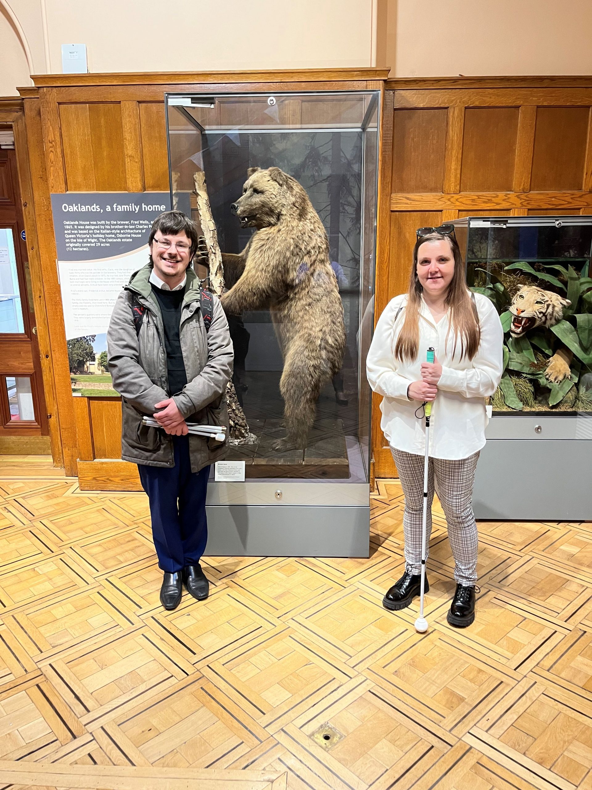 Essex SLC member, Alexander Ramzan, with Engagement Manager, Samantha Leftwich. They are standing in front of 'Boris the bear', an exhibit in the museum.