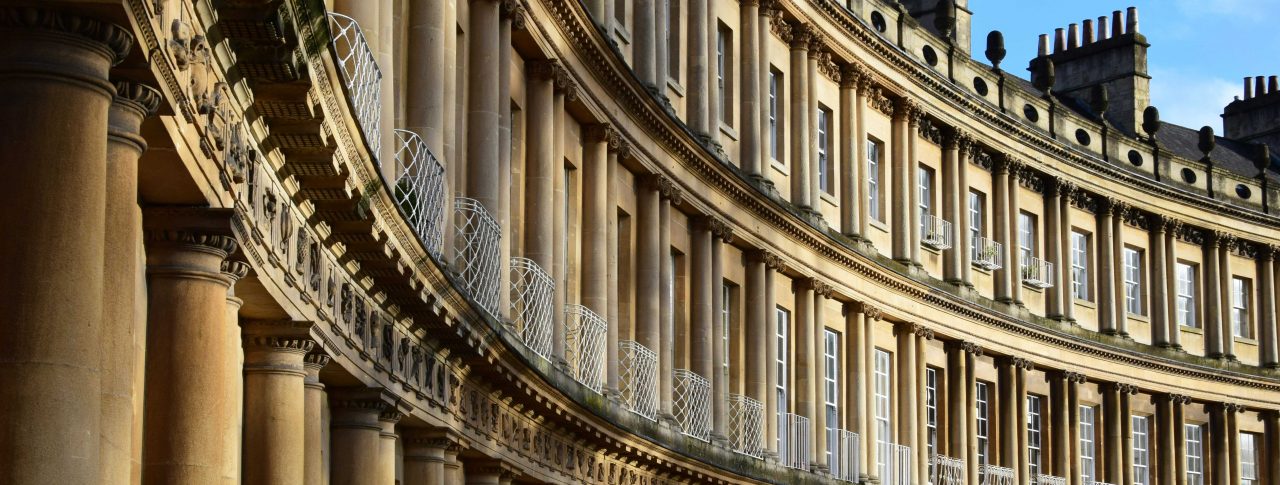 A close up of houses situated in Lansdown Crescent, Bath. The Georgian houses form the shape of an oval, and are iconic in Bath City Centre.