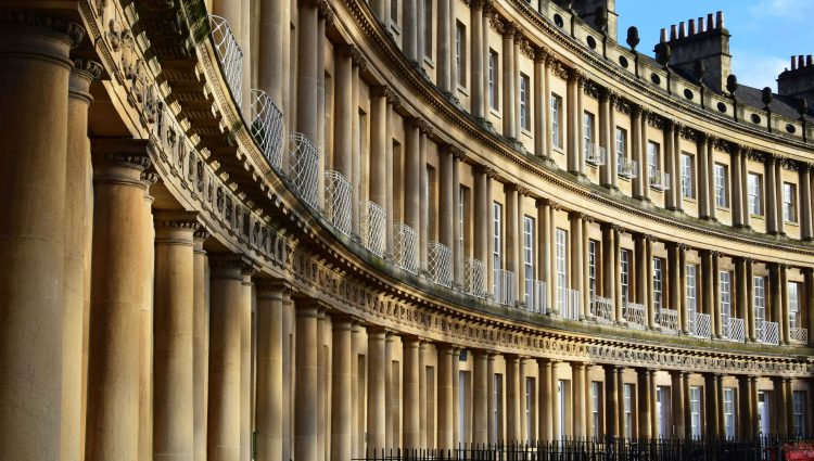 A close up of houses situated in Lansdown Crescent, Bath. The Georgian houses form the shape of an oval, and are iconic in Bath City Centre.