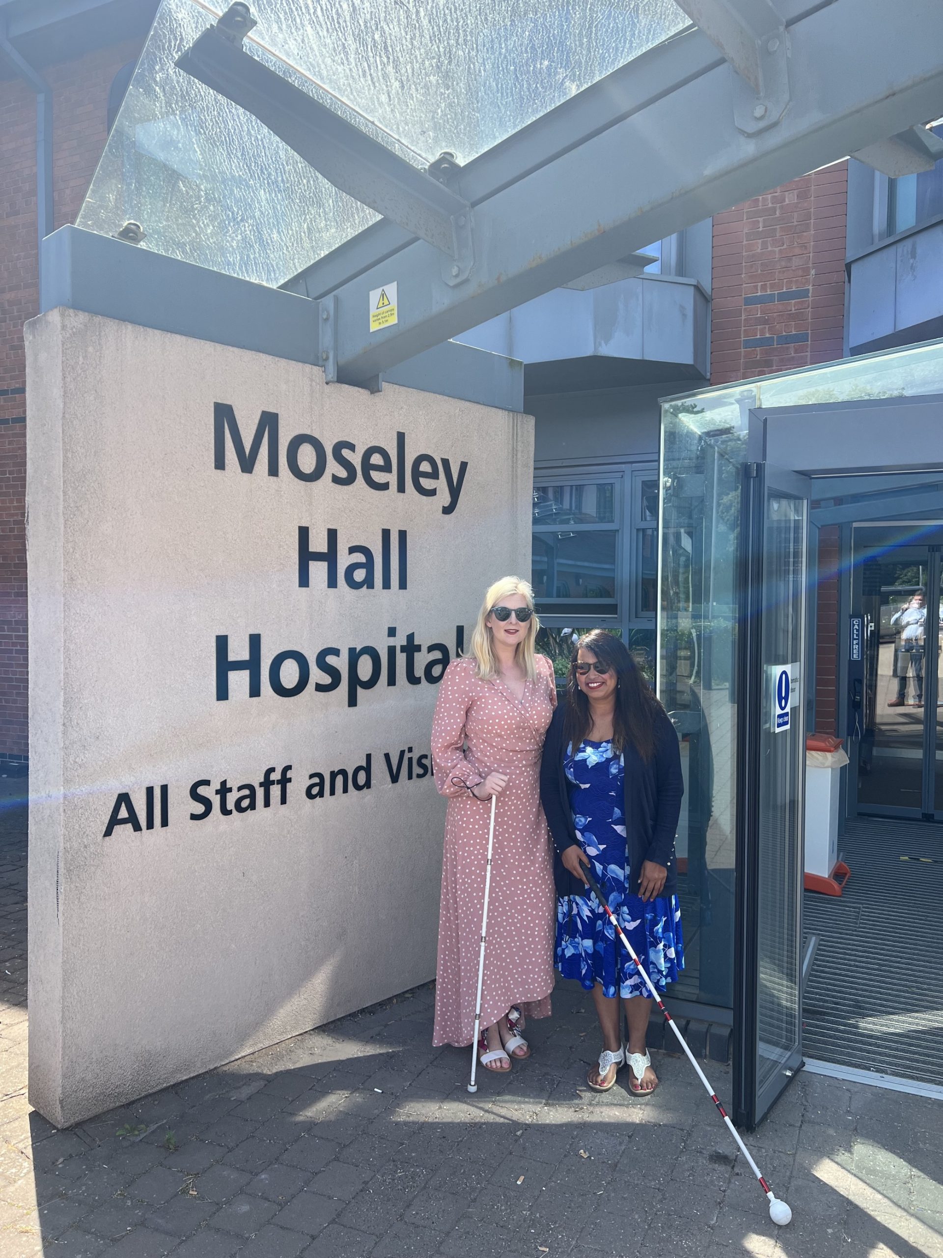 Louise Connop, Senior Engagement Manager for Central England, with Black Country SLC member, Meena Ratu. They are standing outside Moseley Hall Hospital, where they presented at the health care support worker conference.