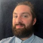 A headshot of Jack Moffat, Engagement Manager for the North East. Jack has dark hair and a beard. He is looking at the camera, smiling.