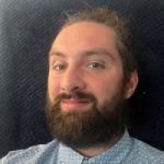 A headshot of Jack Moffat, Engagement Manager for the North East. Jack has dark hair and a beard. He is looking at the camera, smiling.