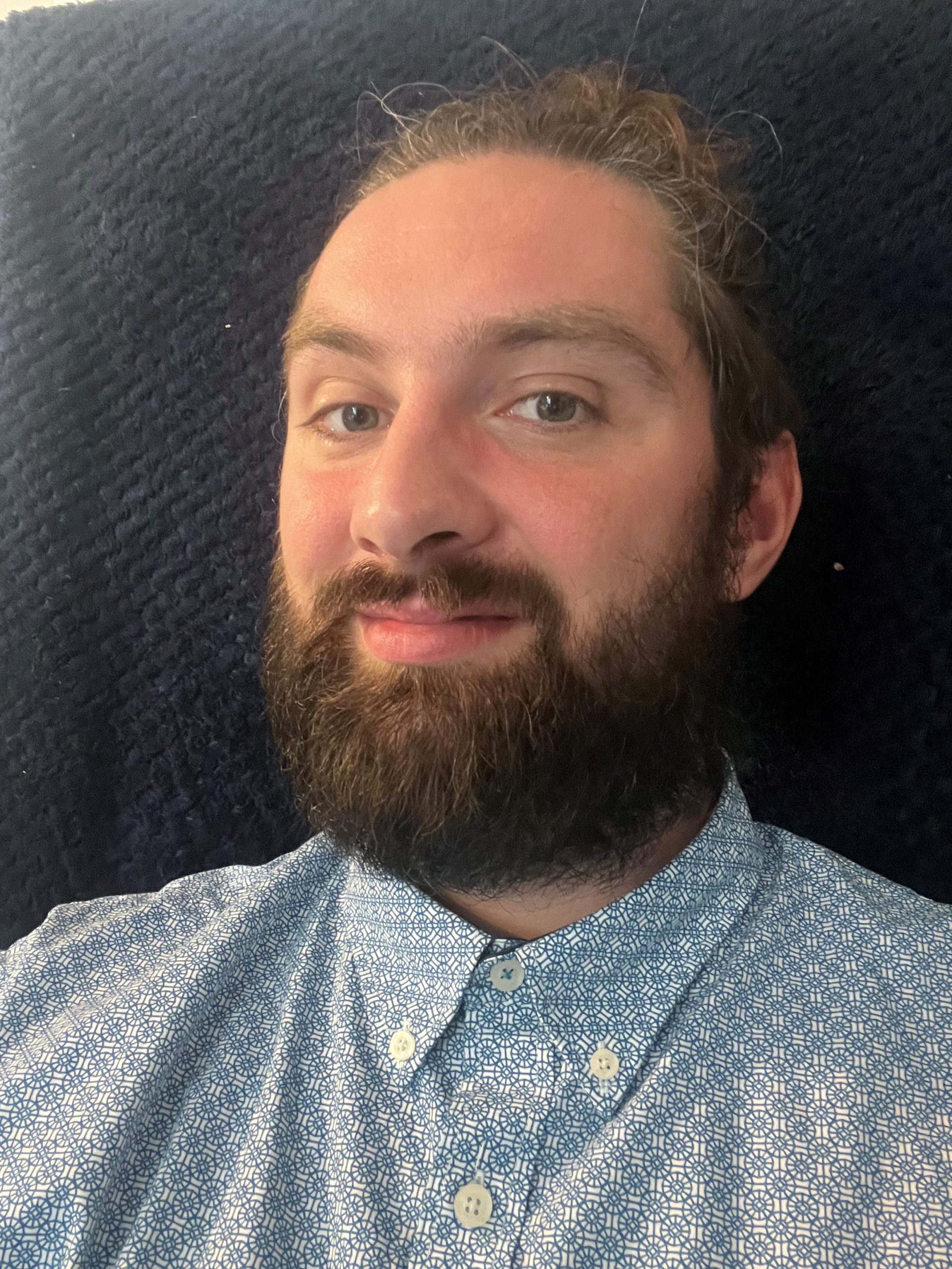 A headshot of Jack Moffat, Engagement Manager for the North East. Jack has dark hair and a beard. He is looking at the camera, smiling.