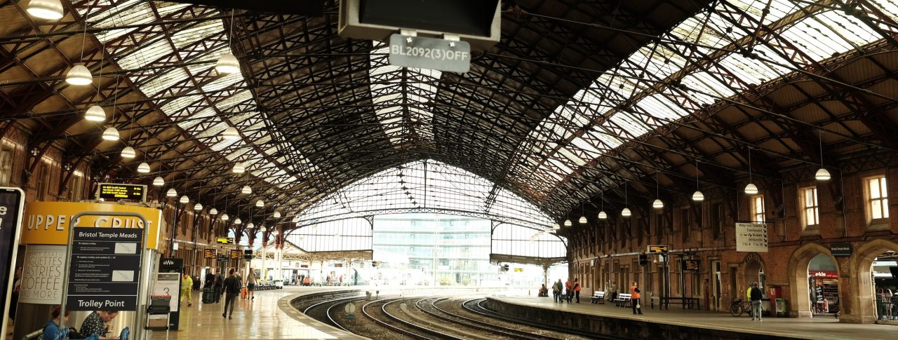 The interior of Bristol Station with a departure board.