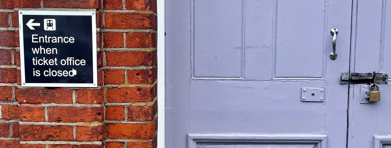 Image of a closed door at a ticket office. The image shows a sign to the left of the door which reads: 'Entrance when ticket office closed.'