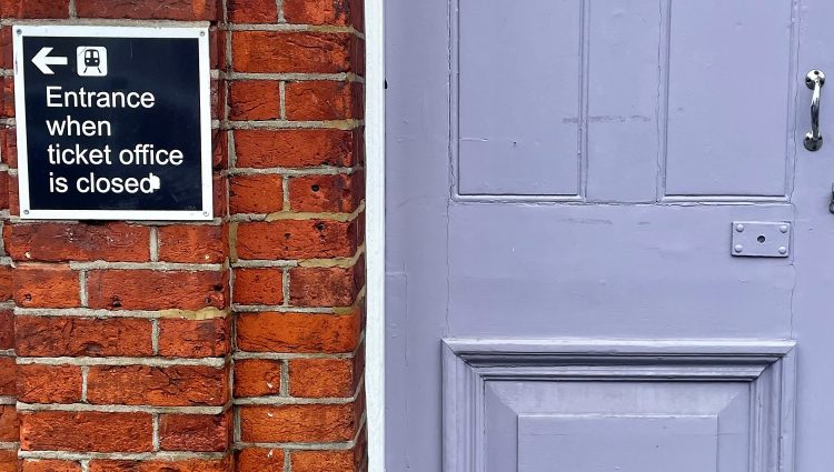 Image of a closed door at a ticket office. The image shows a sign to the left of the door which reads: 'Entrance when ticket office closed.'