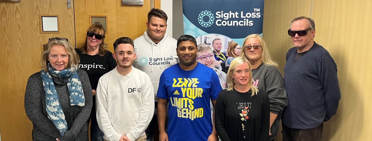 Lancashire Sight Loss Council members, Alison, Lynne, Lloyd, Mohammed Salim, Dawn, and Michael, pictured in front of the Sight Loss Council banner, with David Parfett, SLC coordinator for North West, and Kelly Barton, Engagement Manager for the North West.