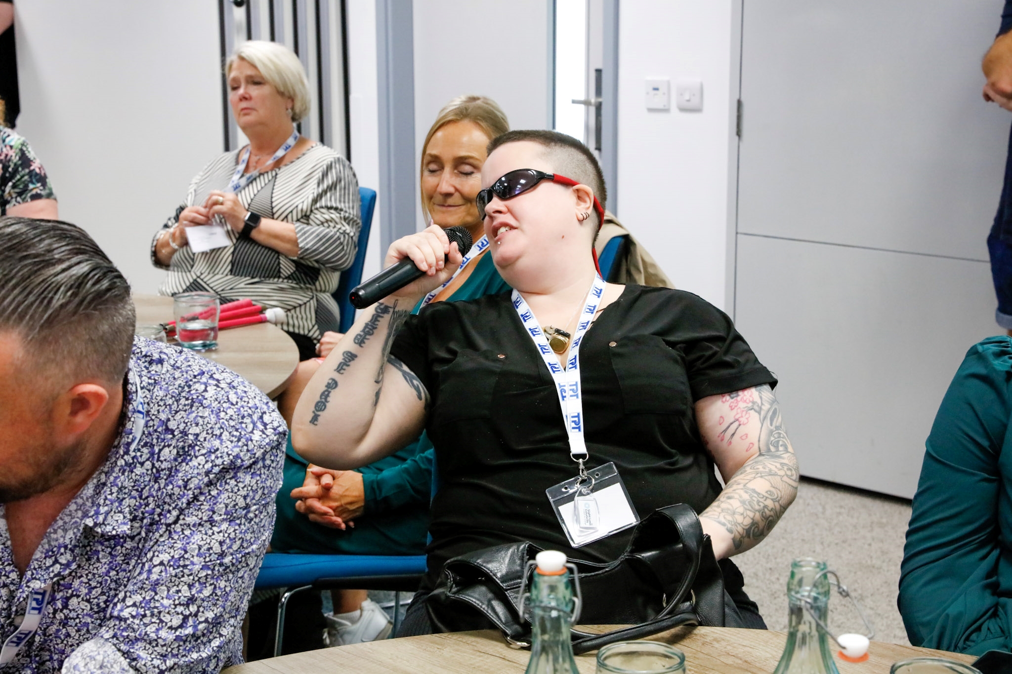 Millie Hayter, Worcestershire SLC member, talking into a microphone during the SLC conference.