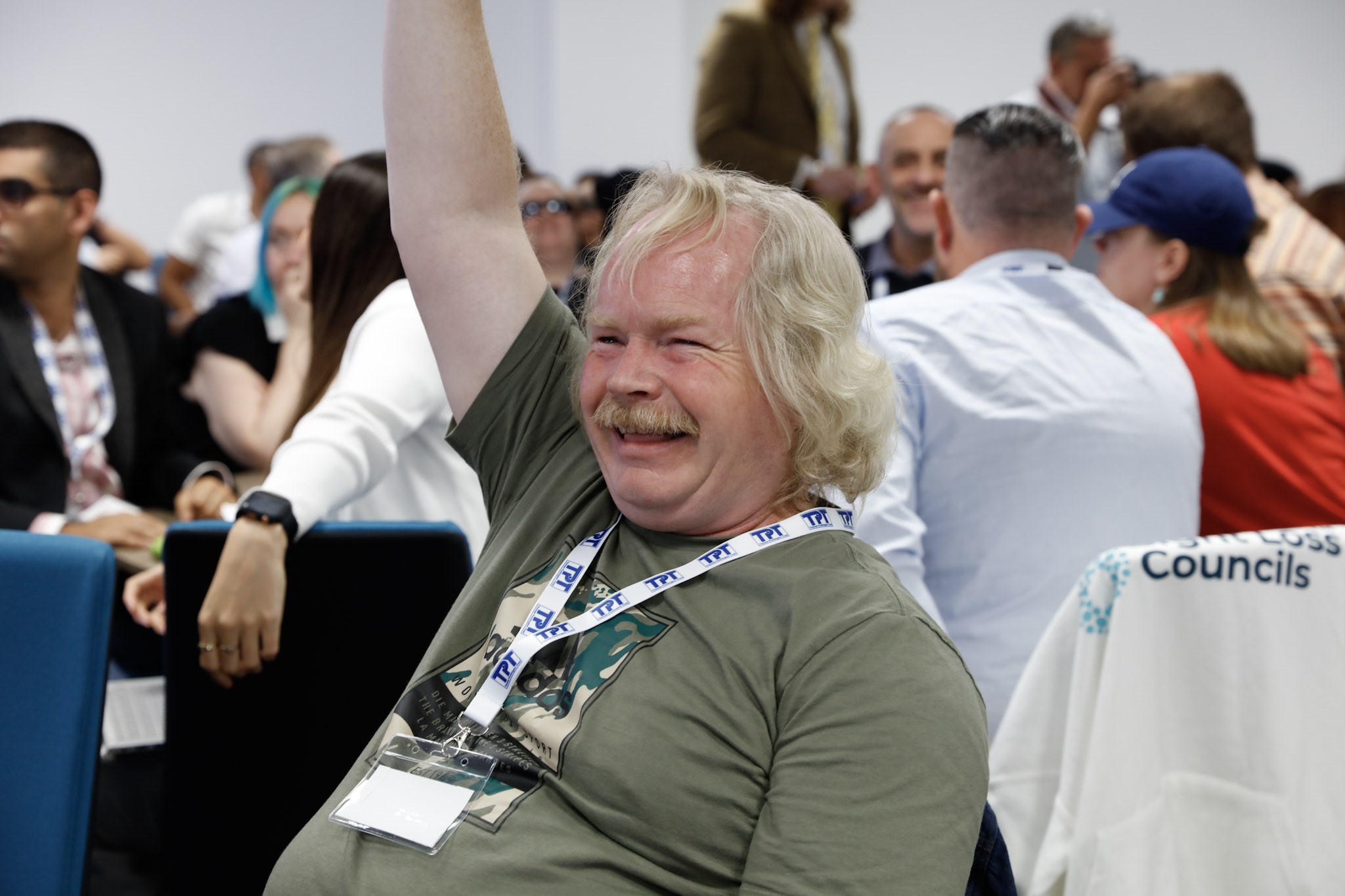 Steve Keith, Birmingham and Black Country SLC member, pictured with his hand in the air whilst smiling during a workshop