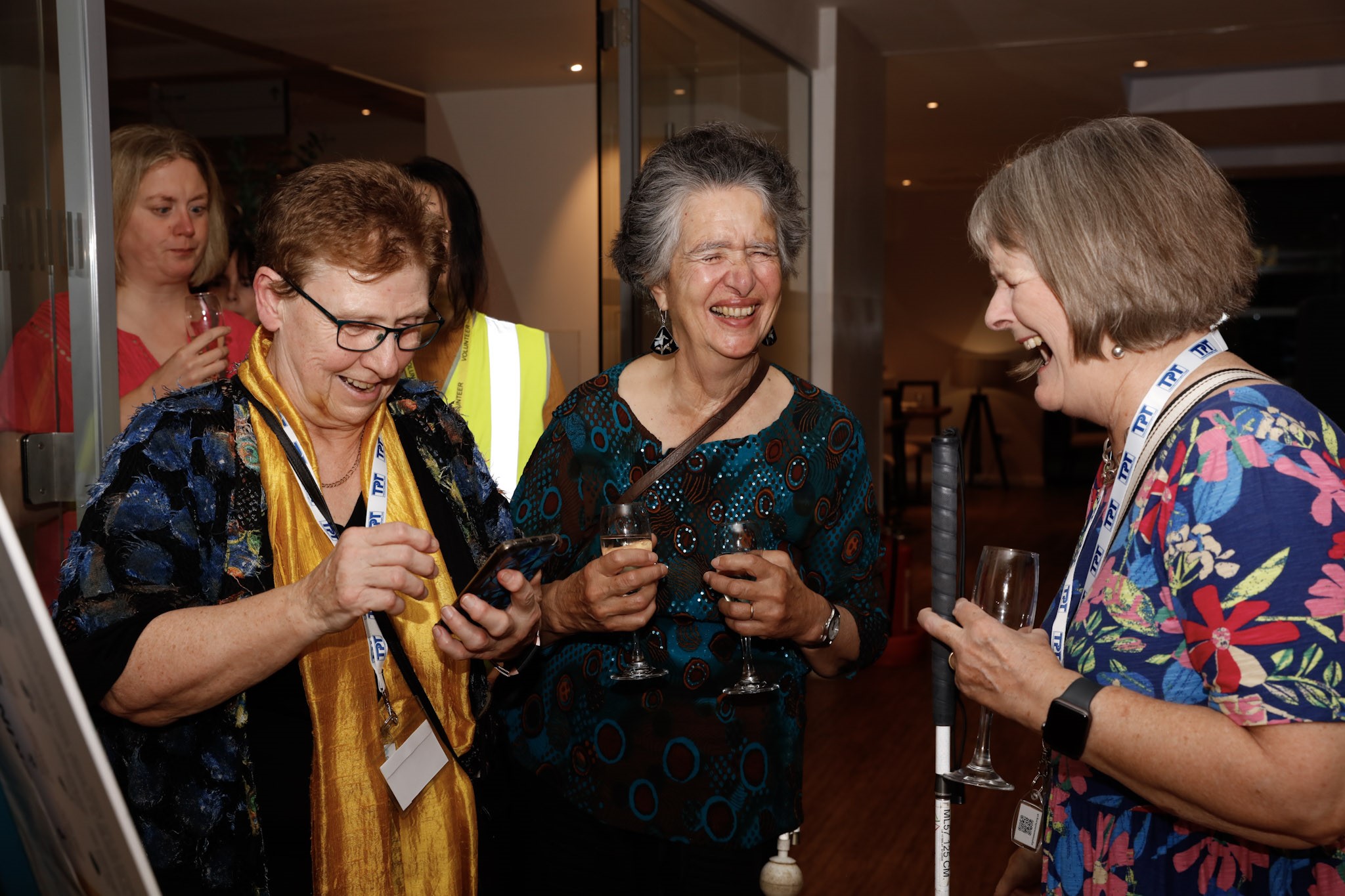 Lesley Robinson, Anna Baldwin, and Josie Clark, North Yorkshire SLC members. They are pictures talking to each other, laughing, at the Rodney Powell Awards.