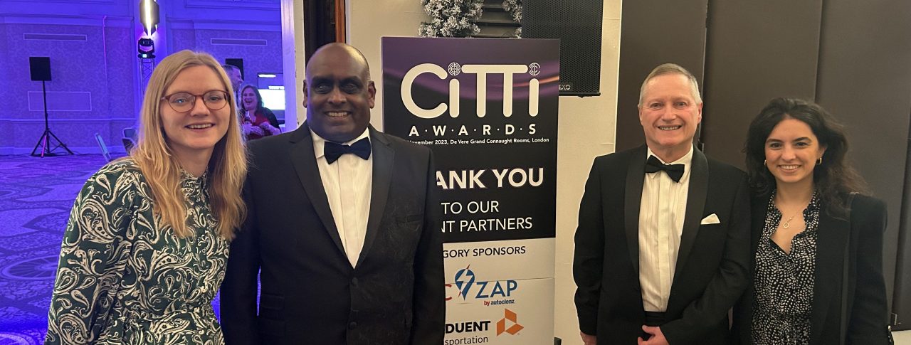 Lucy Williams, Senior Engagement Manager for South England, with Haren and Harry, South West London SLC volunteers, and Fiona Duenyas, Public Affairs Manager at Lime. They are stood by the entrance to the awards cermony, in front of a CiTTi Awards banner.