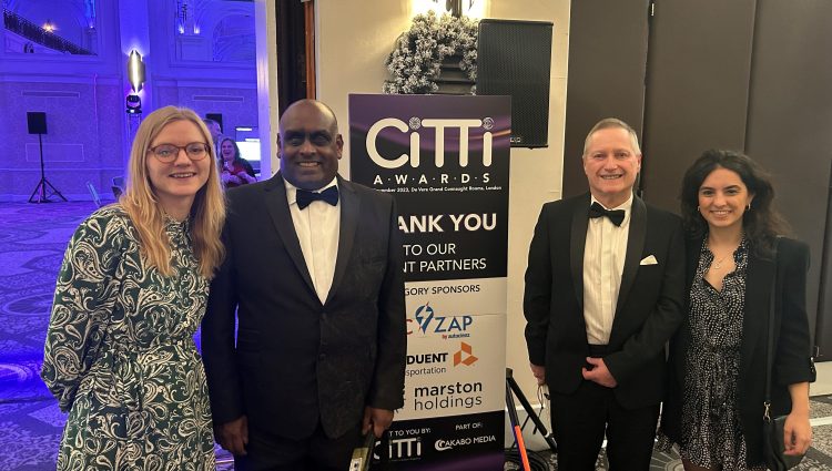 Lucy Williams, Senior Engagement Manager for South England, with Haren and Harry, South West London SLC volunteers, and Fiona Duenyas, Public Affairs Manager at Lime. They are stood by the entrance to the awards cermony, in front of a CiTTi Awards banner.