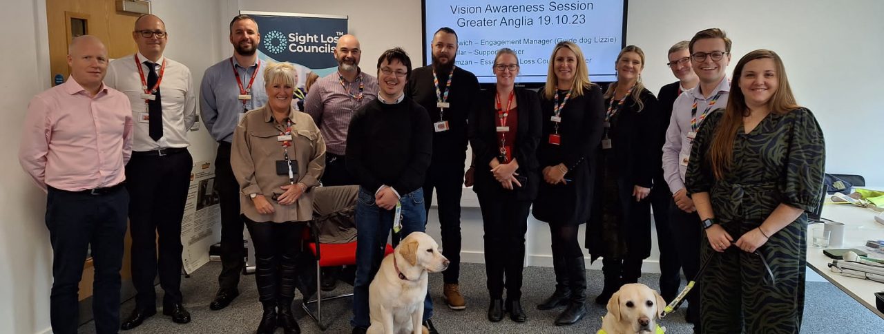 Staff from Greater Anglia's management team, stood with Samantha Leftwich, Engagement Manager for East England and Guide Dog Lizzie, and Essex SLC member, Alex Ramzan and his guide dog.