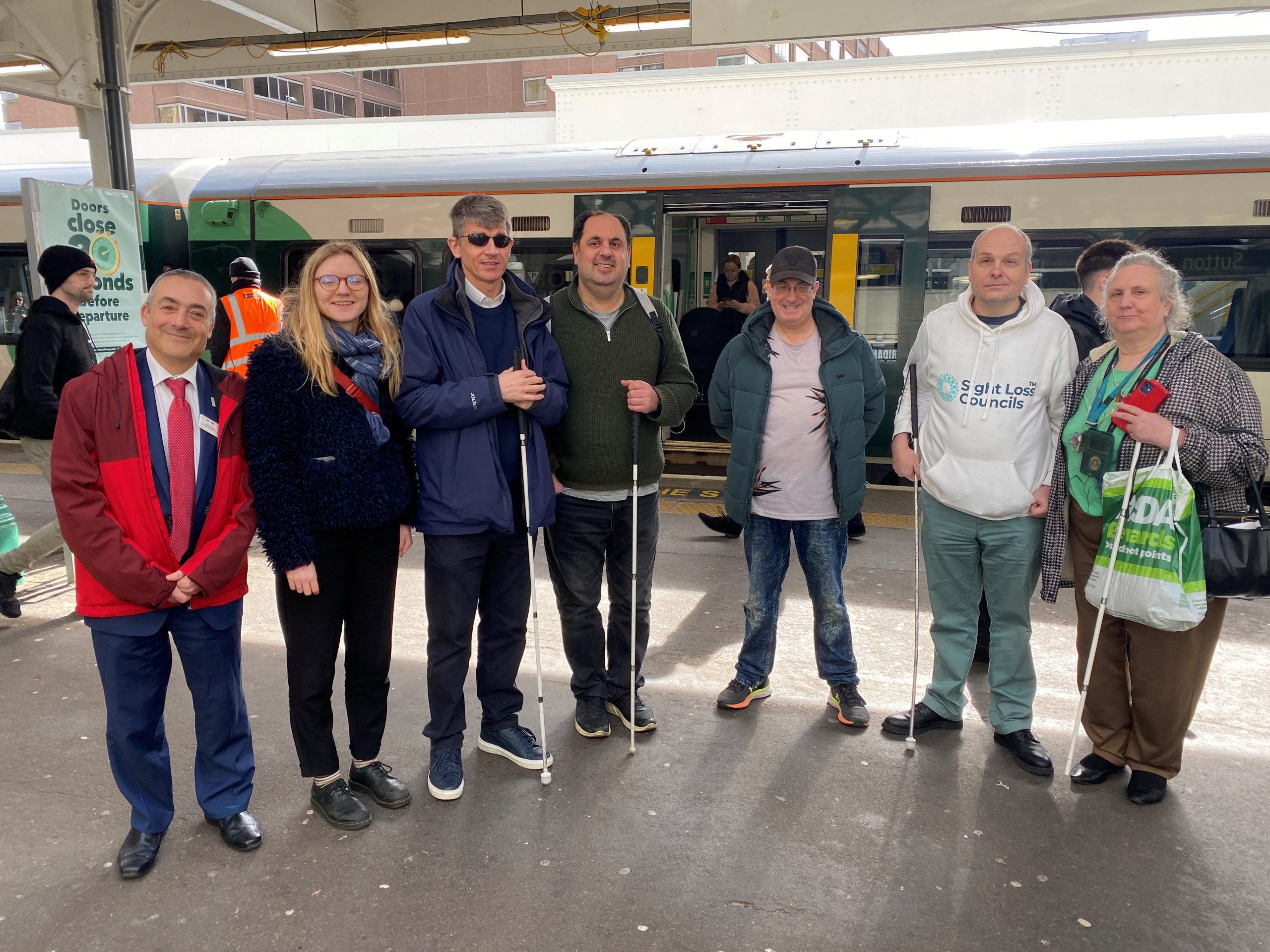 Antony Merlyn, Accessibility Engagement Manager at Govia, standing with Lucy Williams, Senior Engagement Manager for South England, Dave Smith, Engagement Manager for South East England, Liam o'Caroll, London SLC coordinator, and volunteers.