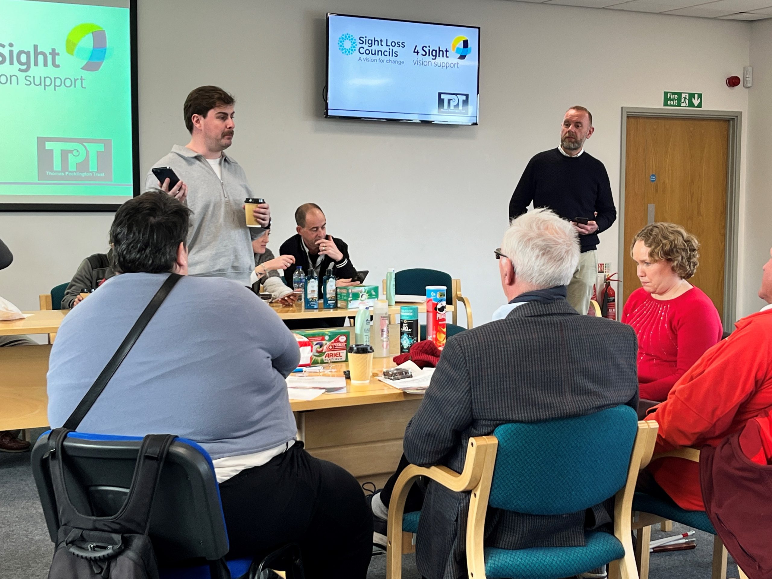 Paul Gallagher, P&G, and Oran McAlistair, NaviLens, are both standing during their presentation to blind and partially sighted delegates.