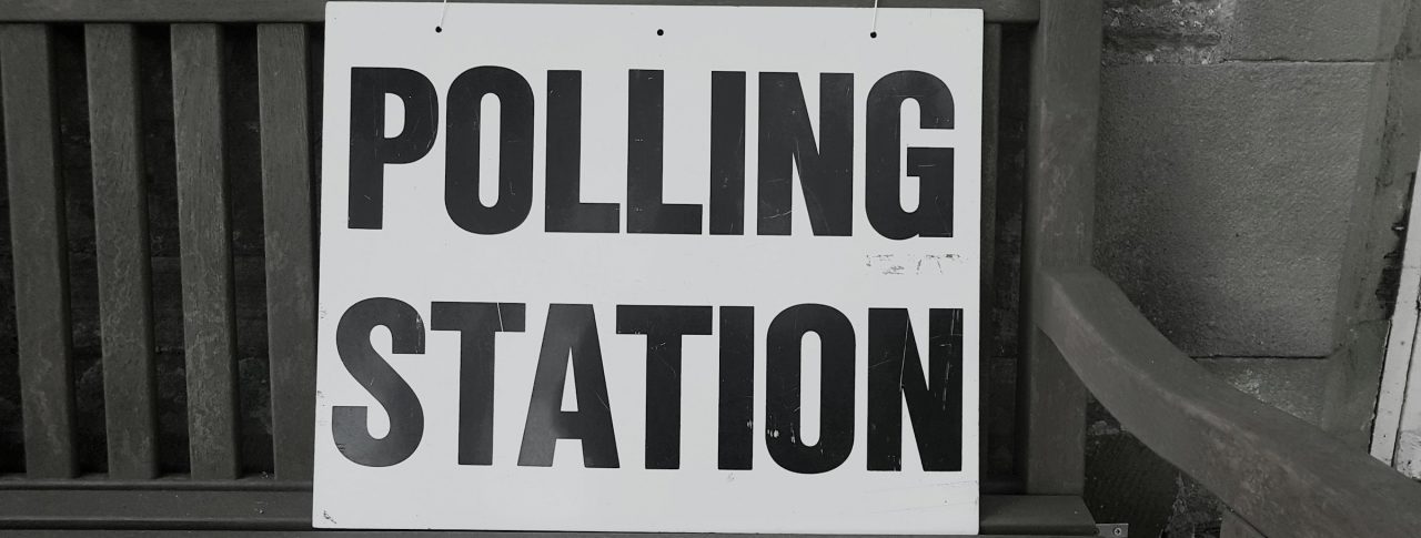 A sign on a bench that reads 'Polling Station'