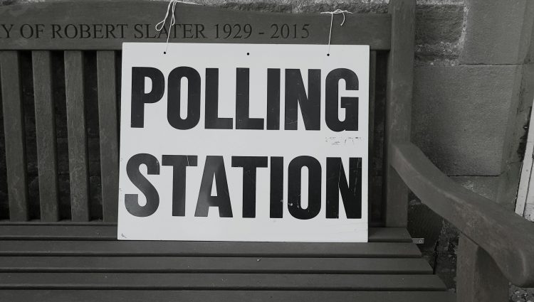 A sign on a bench that reads 'Polling Station'